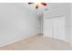 This bedroom features neutral walls, carpet floors, a ceiling fan, and closet doors at 13334 Palmera Vista Dr, Riverview, FL 33579