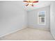 Light-filled bedroom featuring plush carpet, a ceiling fan, and a large window offering natural light at 13334 Palmera Vista Dr, Riverview, FL 33579