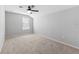 Bright bedroom featuring neutral walls and carpet, enhanced by a contemporary ceiling fan at 13334 Palmera Vista Dr, Riverview, FL 33579