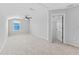 Bright bonus room with neutral carpet, ceiling fan, and doorway to another room at 13334 Palmera Vista Dr, Riverview, FL 33579