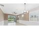 Dining room featuring tile flooring, modern lighting, and sliding glass doors to the screened patio at 13334 Palmera Vista Dr, Riverview, FL 33579