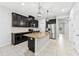 Kitchen featuring dark cabinetry, granite countertops, and stainless steel appliances at 13334 Palmera Vista Dr, Riverview, FL 33579