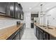 Kitchen featuring dark cabinetry, granite countertops, tile backsplash, and modern appliances at 13334 Palmera Vista Dr, Riverview, FL 33579