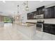 Kitchen with granite countertops, tile backsplash, stainless steel appliances, and island at 13334 Palmera Vista Dr, Riverview, FL 33579