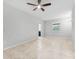 This living room has neutral paint, tile flooring, and a ceiling fan, creating a comfortable and inviting atmosphere at 13334 Palmera Vista Dr, Riverview, FL 33579