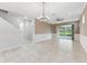 Bright living room featuring tile floors, recessed lighting, fan, and sliding glass doors to the outside at 13334 Palmera Vista Dr, Riverview, FL 33579