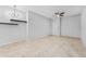 Neutral living room with tile floors, ceiling fan, built-in shelves, and light-colored walls create a serene space at 13334 Palmera Vista Dr, Riverview, FL 33579