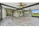 A screened-in patio has tiled floors and ceiling fans for optimal comfort at 13334 Palmera Vista Dr, Riverview, FL 33579