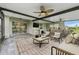 Relaxing covered patio with ceiling fans, comfortable seating, and outdoor dining area at 13334 Palmera Vista Dr, Riverview, FL 33579