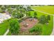 Aerial view of a modern playground with slides and climbing structures surrounded by lush landscaping at 13334 Palmera Vista Dr, Riverview, FL 33579