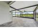 Large screened porch with tile flooring and views of the pond at 13334 Palmera Vista Dr, Riverview, FL 33579