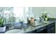 Double sink bathroom vanity with granite countertops, dark cabinets, and decorative jars with shells and cotton balls at 13520 White Sapphire Rd, Riverview, FL 33579