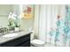 Bathroom vanity with granite countertop, white sink, and a decorative shower curtain with colorful coral and fish design at 13520 White Sapphire Rd, Riverview, FL 33579