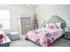 Charming bedroom with floral bedding, gray furniture, and decorative accents, creating a cozy and inviting atmosphere at 13520 White Sapphire Rd, Riverview, FL 33579