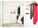 Walk-in closet with custom shelving and hanging rods, providing ample storage and organization space for clothing and accessories at 13520 White Sapphire Rd, Riverview, FL 33579