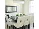 Elegant dining room with a modern chandelier, a large mirror, and a stylish dark-wood table at 13520 White Sapphire Rd, Riverview, FL 33579