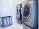 Modern laundry room featuring new front loading washer and dryer and a convenient sorter at 13520 White Sapphire Rd, Riverview, FL 33579