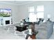 Bright and airy living room with a fireplace, a large TV, and comfortable sofas at 13520 White Sapphire Rd, Riverview, FL 33579