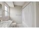 This bathroom features a single sink vanity, a window, and a shower-tub combo at 13986 Bonnie Brae Dr, Largo, FL 33774