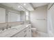 This bathroom features a double sink vanity, a window, and a shower-tub combo at 13986 Bonnie Brae Dr, Largo, FL 33774