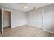 This bedroom features hardwood floors, a closet, and leads to another room at 13986 Bonnie Brae Dr, Largo, FL 33774