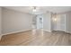 This bedroom features hardwood floors, a ceiling fan, and an ensuite bathroom at 13986 Bonnie Brae Dr, Largo, FL 33774