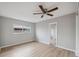 This bedroom features hardwood floors, a ceiling fan, and a window at 13986 Bonnie Brae Dr, Largo, FL 33774