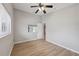 Bedroom featuring light hardwood floors, neutral walls, a window and a ceiling fan at 13986 Bonnie Brae Dr, Largo, FL 33774
