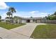 Charming home with a spacious driveway, stone accents, mature landscaping, and a well-maintained lawn at 13986 Bonnie Brae Dr, Largo, FL 33774