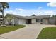 Charming single-Gathering home with stone accents, mature landscaping, and a spacious driveway at 13986 Bonnie Brae Dr, Largo, FL 33774