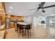 Spacious kitchen with a center island, wood cabinets, stainless appliances, and a view to the living room at 13986 Bonnie Brae Dr, Largo, FL 33774