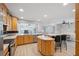 Open kitchen featuring wood cabinets and stainless appliances with a view to the dining and living rooms at 13986 Bonnie Brae Dr, Largo, FL 33774