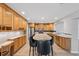 Bright kitchen features wood cabinets, a center island with bar seating, and stainless steel appliances at 13986 Bonnie Brae Dr, Largo, FL 33774