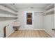 Laundry room with sink, shelving and tile flooring for easy maintenance at 13986 Bonnie Brae Dr, Largo, FL 33774