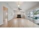 Spacious living room featuring natural light, a fireplace, and sliding glass doors to the lanai at 13986 Bonnie Brae Dr, Largo, FL 33774