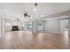 Spacious living room with hardwood floors and a fireplace featuring access to the lanai and pool at 13986 Bonnie Brae Dr, Largo, FL 33774