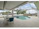 Screened in swimming pool with a hot tub and an outdoor seating area at 13986 Bonnie Brae Dr, Largo, FL 33774