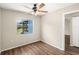 Bedroom showcasing wood-look floors and a bright window with a backyard view at 1421 Vinetree Dr, Brandon, FL 33510