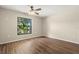 Bedroom with wood floors and a window with lush green views at 1421 Vinetree Dr, Brandon, FL 33510