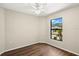 Bedroom with wood-look flooring, ceiling fan, and a bright window at 1421 Vinetree Dr, Brandon, FL 33510