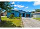 Charming blue single Gathering home with a well-kept lawn and driveway at 1421 Vinetree Dr, Brandon, FL 33510