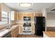 Kitchen with stainless steel appliances, wood cabinets, and a view to the dining area at 1421 Vinetree Dr, Brandon, FL 33510