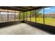 Covered lanai with a view of the grassy backyard and mature trees at 1421 Vinetree Dr, Brandon, FL 33510