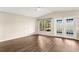 Bright living room featuring wood floors, a large window, and a glass door to a patio at 1421 Vinetree Dr, Brandon, FL 33510