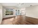 Spacious living room with wood floors, window, glass door, and a bar area at 1421 Vinetree Dr, Brandon, FL 33510