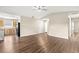 Open-concept living room with wood floors flowing into the kitchen with stainless steel appliances at 1421 Vinetree Dr, Brandon, FL 33510