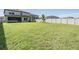 Expansive backyard featuring a well-kept lawn, mature trees, and white vinyl privacy fence at 14626 Horse Trot Rd, Lithia, FL 33547