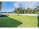 Large, lush backyard with a well-manicured lawn and white vinyl privacy fence at 14626 Horse Trot Rd, Lithia, FL 33547