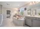 Beautiful bathroom featuring a soaking tub, walk-in shower, double vanity and a view overlooking the backyard at 14626 Horse Trot Rd, Lithia, FL 33547