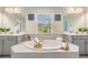 Luxurious bathroom featuring a large tub, gray vanities, and mirrors offering a spa-like ambiance at 14626 Horse Trot Rd, Lithia, FL 33547
